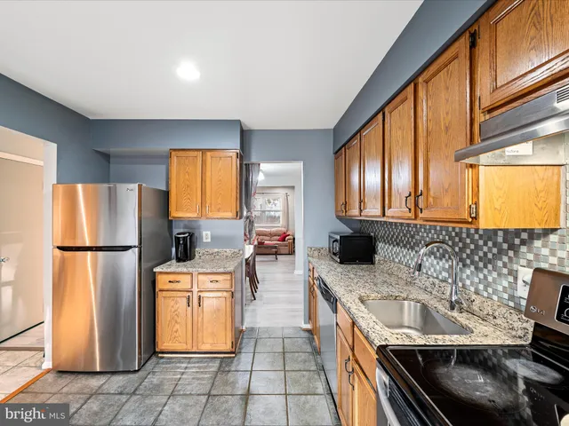 a kitchen with a sink a stove and refrigerator