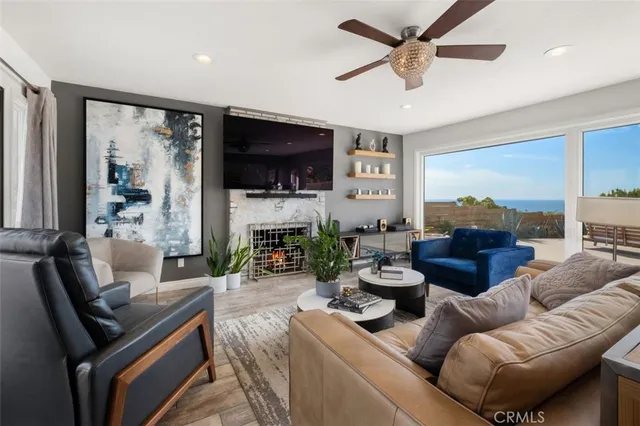 a living room with furniture a fireplace and a flat screen tv