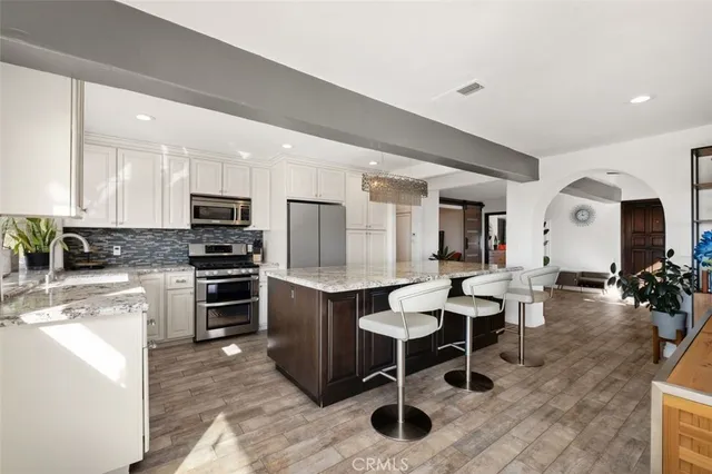 a living room with furniture a flat screen tv and a large window