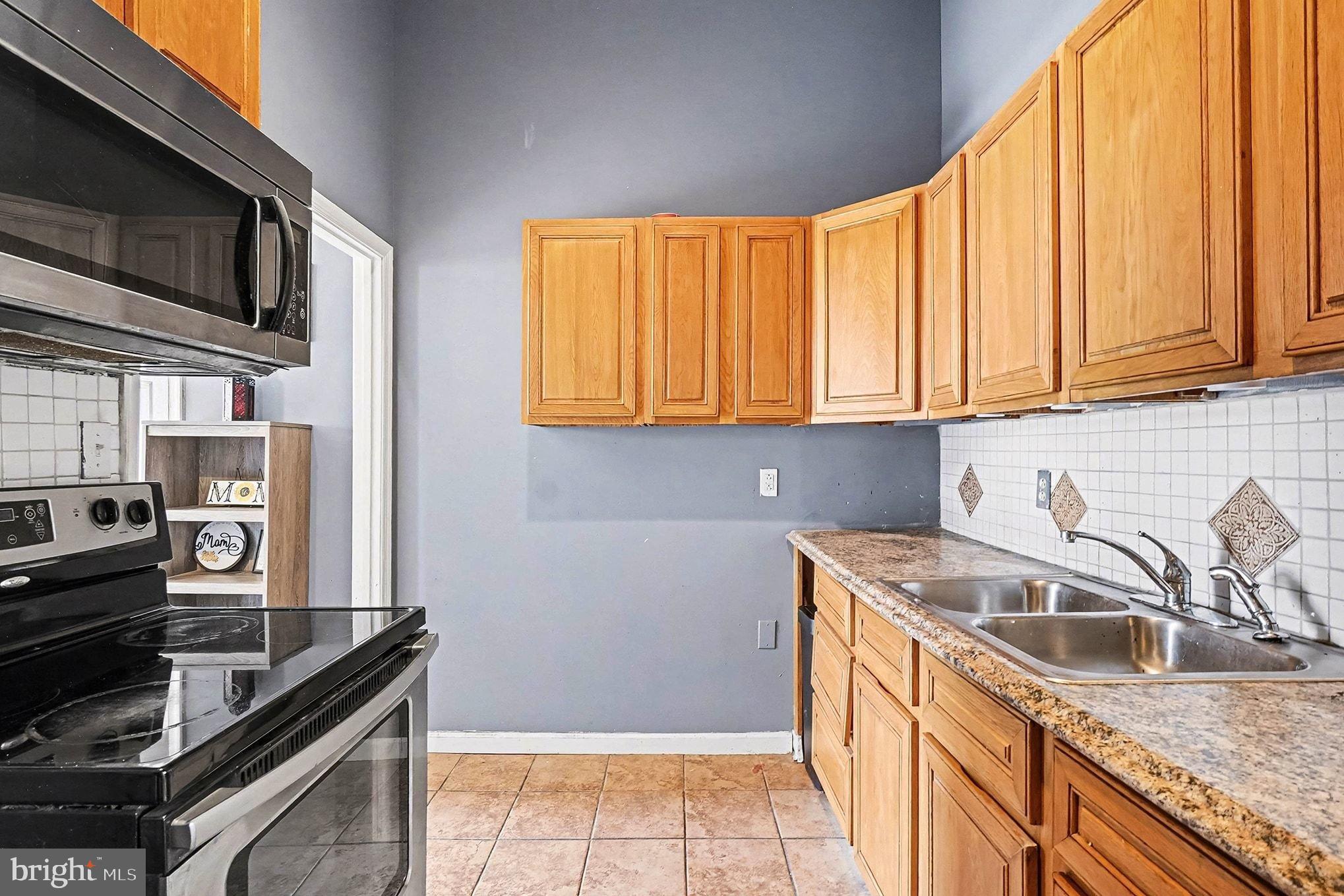 8 Cherry Lane Perryville, MD 21903 - Photo 35 of 57 a kitchen with stainless steel appliances granite countertop a sink stove and refrigerator