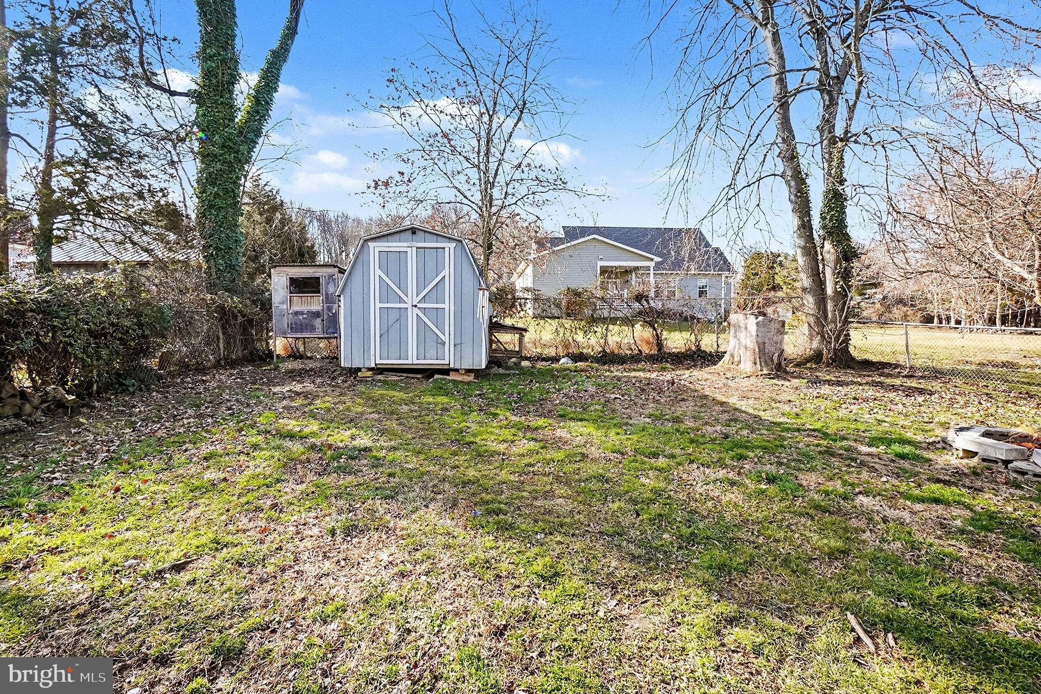 8 Cherry Lane Perryville, MD 21903 - Photo 51 of 57 a front view of a house with a yard covered with trees