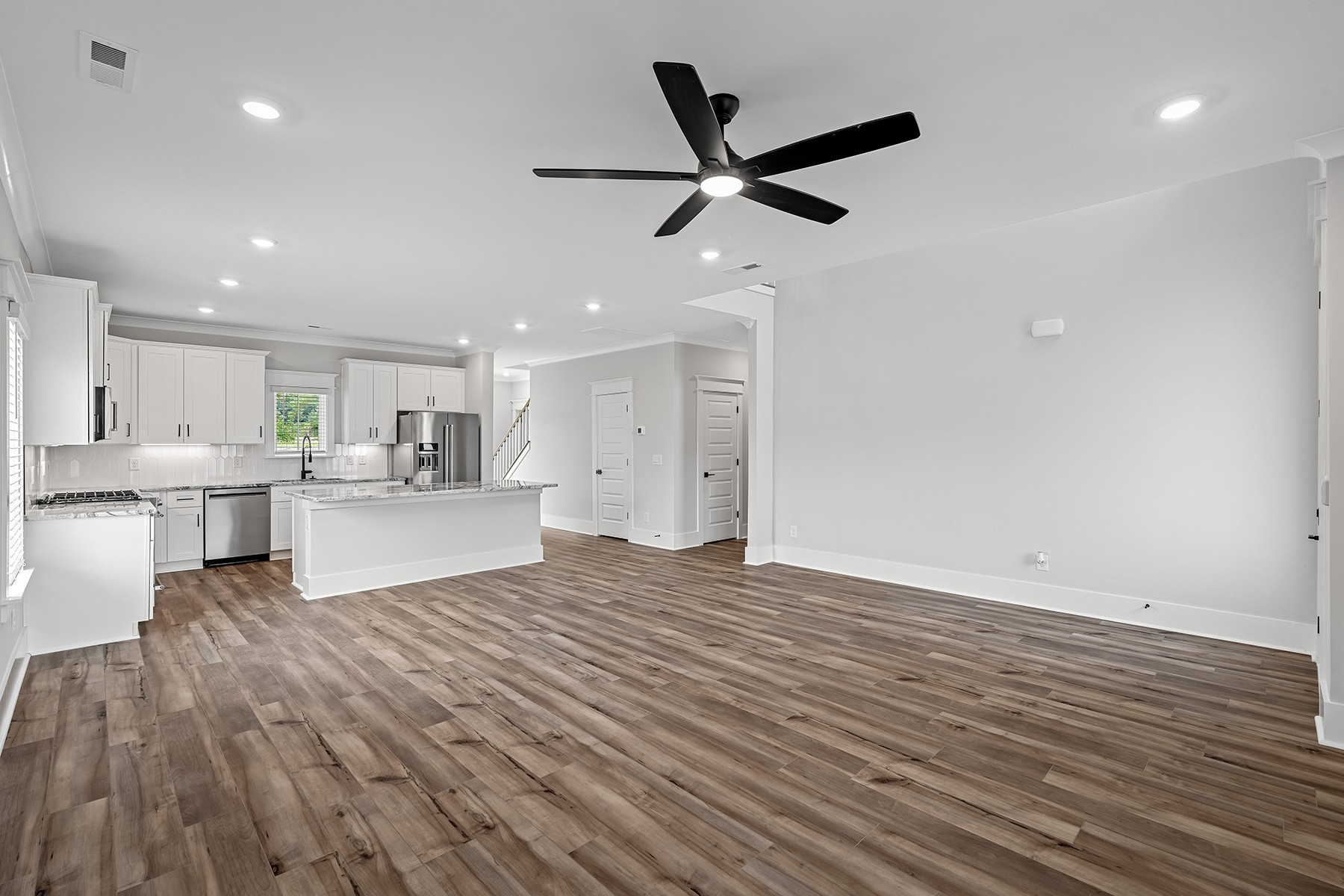 608 Silver Trace White House, TN 37188 - Photo 3 of 19 a view of a kitchen with kitchen island wooden floors appliances and a fireplace