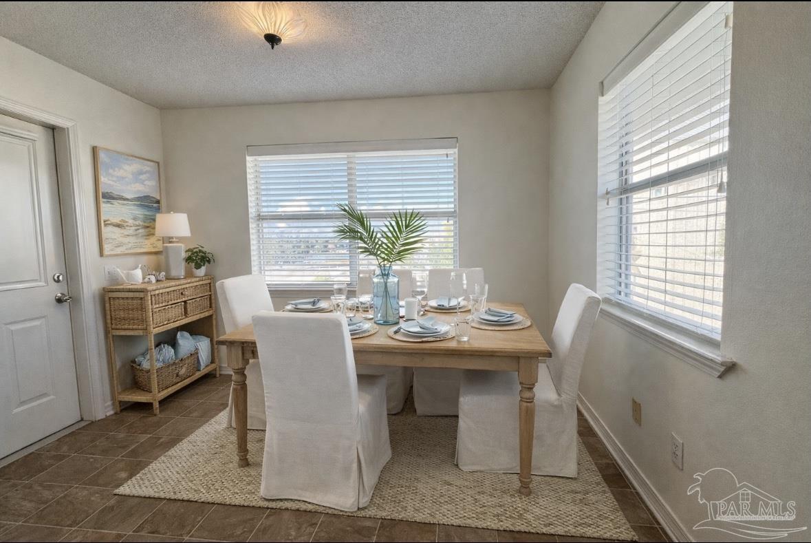 13944 River Road, Unit D Pensacola, FL 32507 - Photo 13 of 14 a view of a dining room with furniture window and outside view