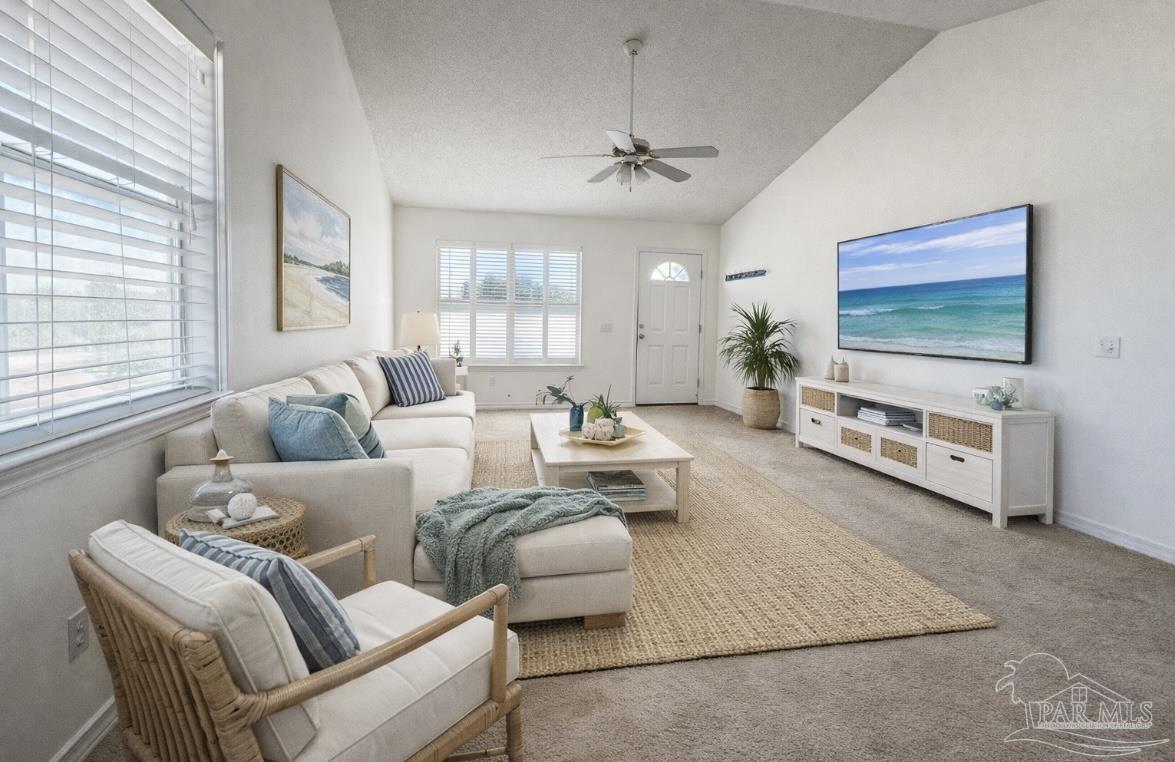 13944 River Road, Unit D Pensacola, FL 32507 - Photo 2 of 14 a living room with furniture and a flat screen tv