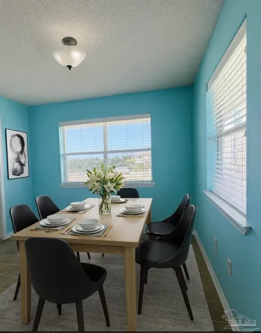 a view of a dining room with furniture and window