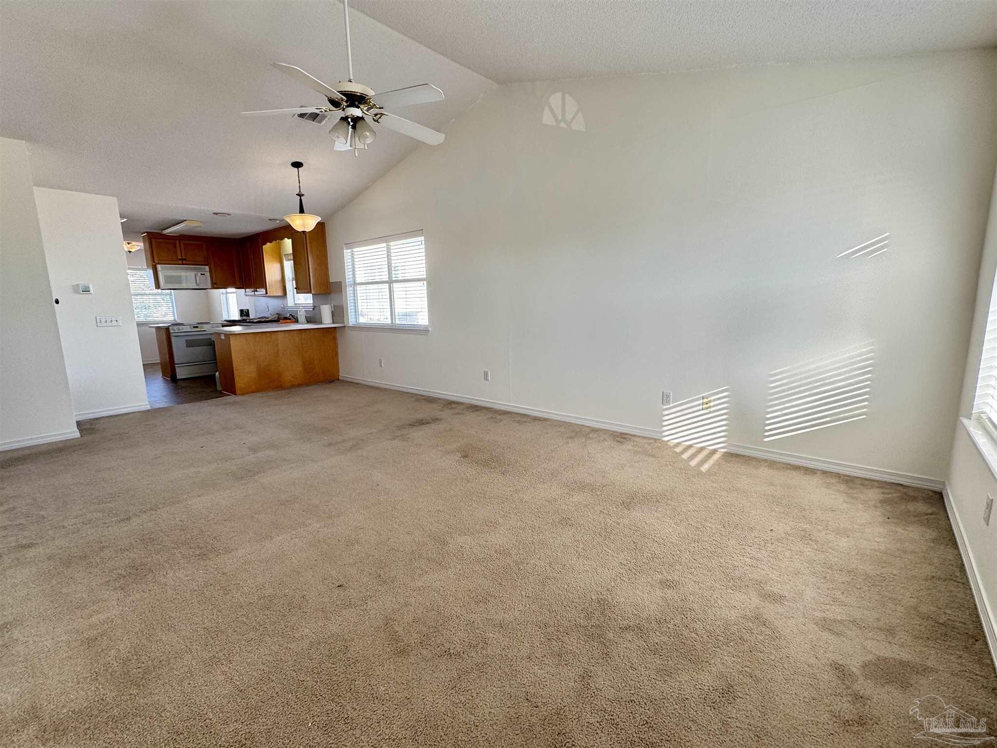 13944 River Road, Unit D Pensacola, FL 32507 - Photo 5 of 14 an empty room with cabinet and windows