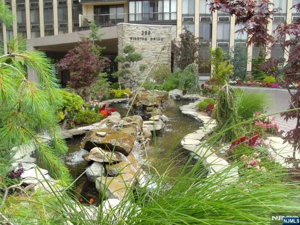 a view of a backyard with plants and seating area