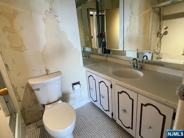 a white toilet sitting next to a bathroom sink