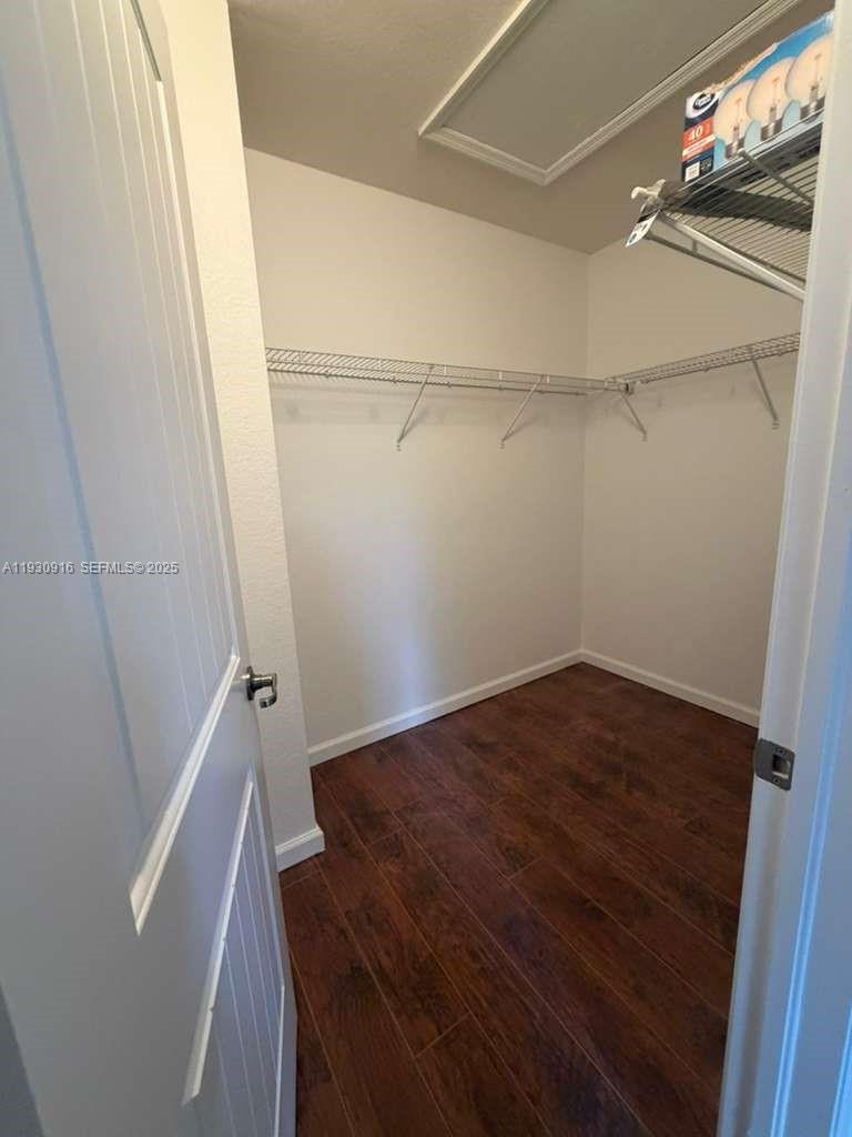 13982 Southwest 276th Street Homestead, FL 33032 - Photo 6 of 15 a view of walk in closet with empty racks