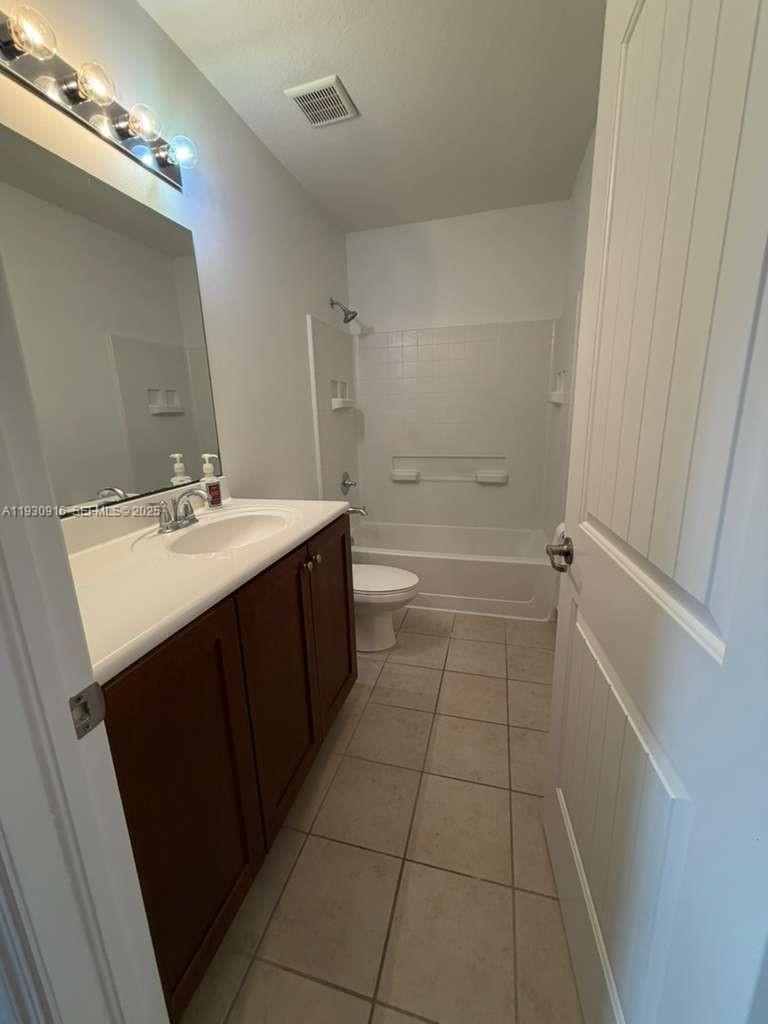 13982 Southwest 276th Street Homestead, FL 33032 - Photo 8 of 15 a bathroom with a sink a toilet and shower