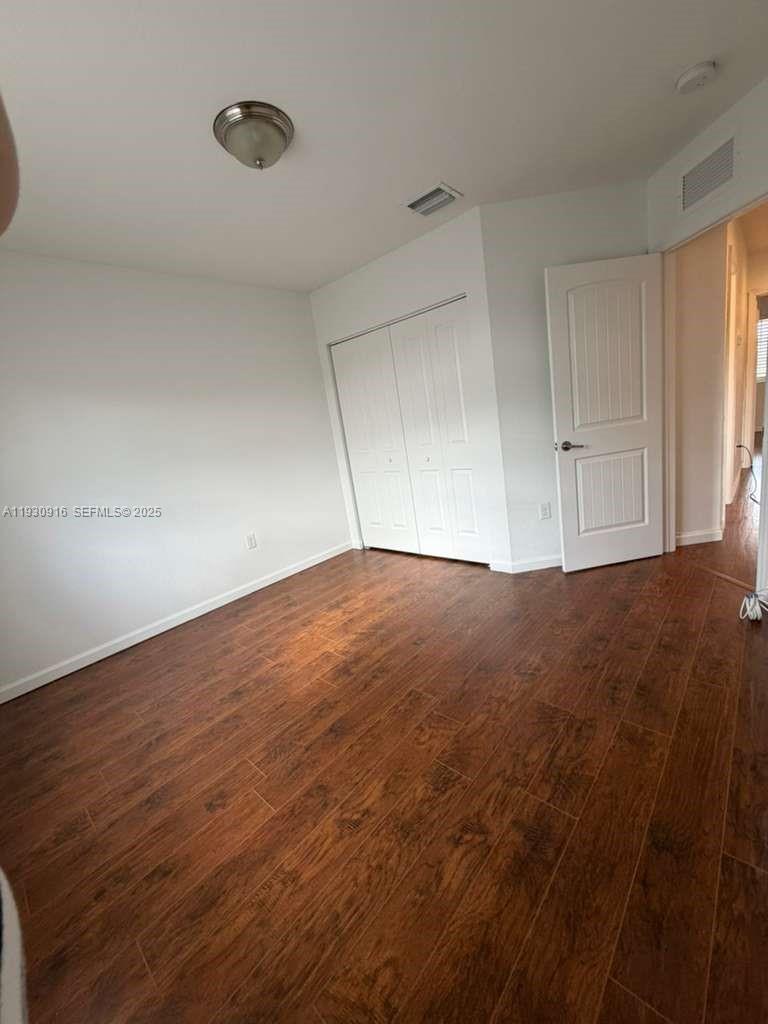 13982 Southwest 276th Street Homestead, FL 33032 - Photo 9 of 15 a view of empty room with wooden floor