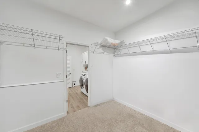 wooden floor in an empty room with a bathroom