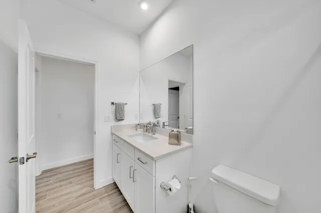 a bathroom with a sink toilet double vanity and tub