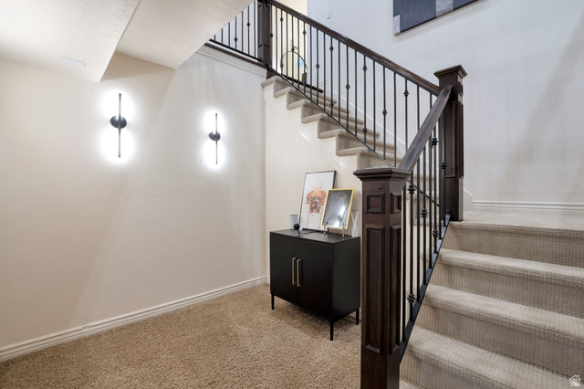577 South Ridge Top Lane East North Salt Lake, UT 84054 - Photo 25 of 57 Custom staircase with wrought iron railing leading to the expansive lower level.