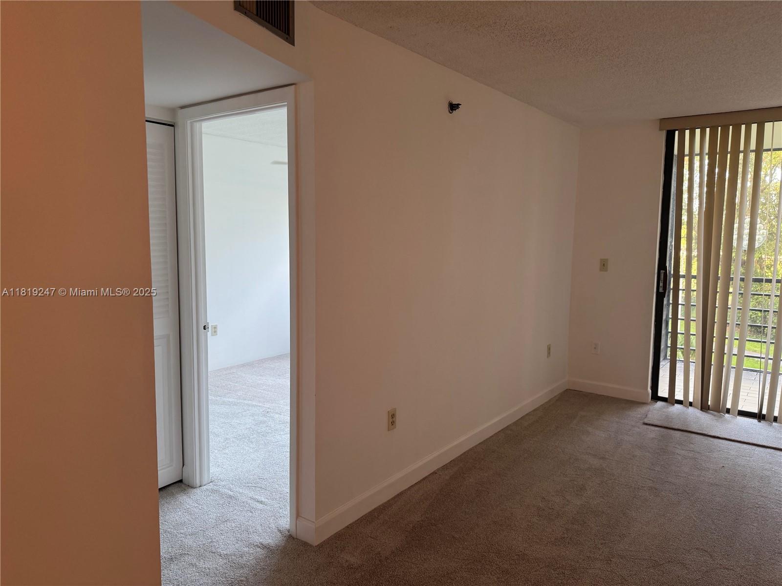 1100 St Charles Place, Unit 203 Pembroke Pines, FL 33026 - Photo 11 of 48 an empty room with windows
