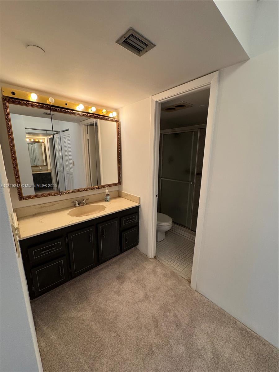1100 St Charles Place, Unit 203 Pembroke Pines, FL 33026 - Photo 16 of 48 a bathroom with a double vanity sink and mirror