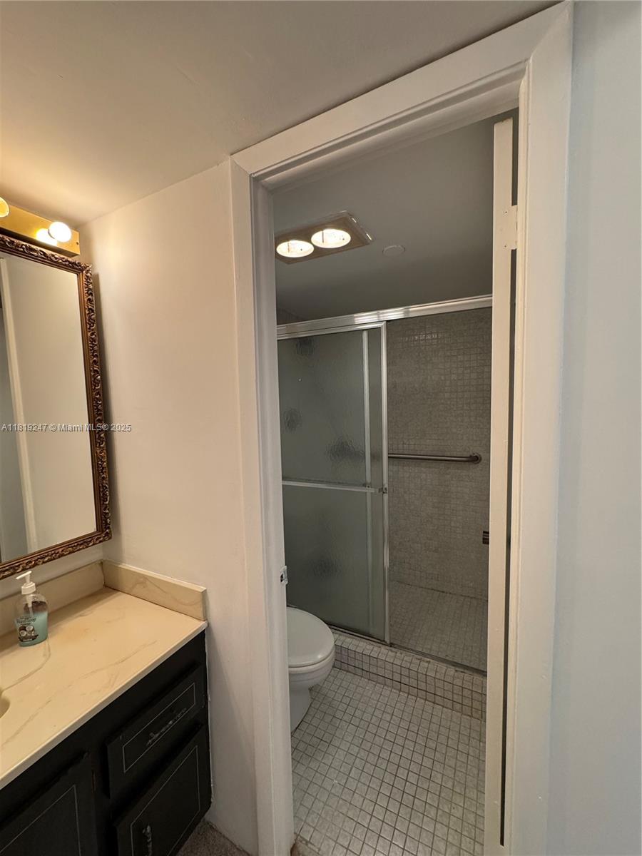 1100 St Charles Place, Unit 203 Pembroke Pines, FL 33026 - Photo 21 of 48 a bathroom with a sink a toilet and shower