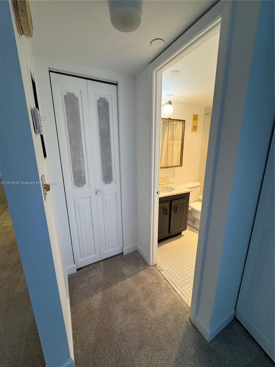 1100 St Charles Place, Unit 203 Pembroke Pines, FL 33026 - Photo 22 of 48 a view of a hallway with wooden floor and entryway