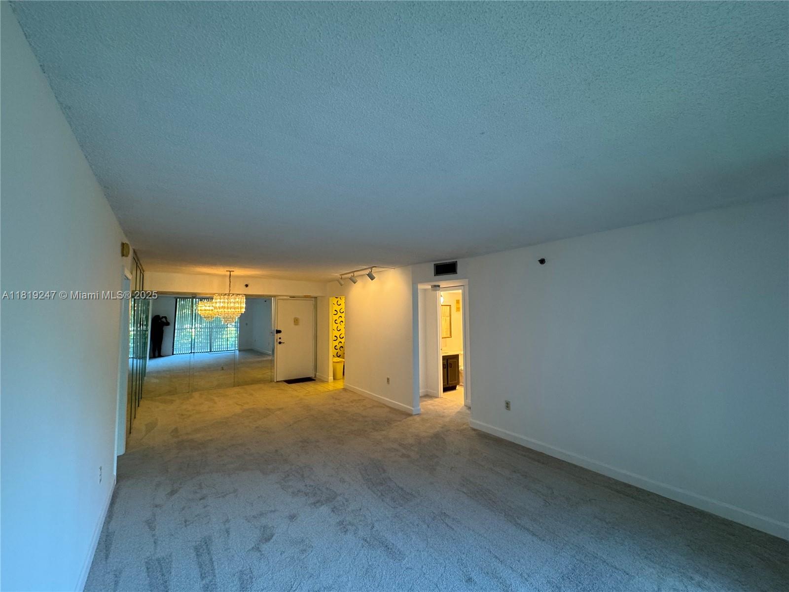 1100 St Charles Place, Unit 203 Pembroke Pines, FL 33026 - Photo 31 of 48 a view of a big room with wooden floor and windows