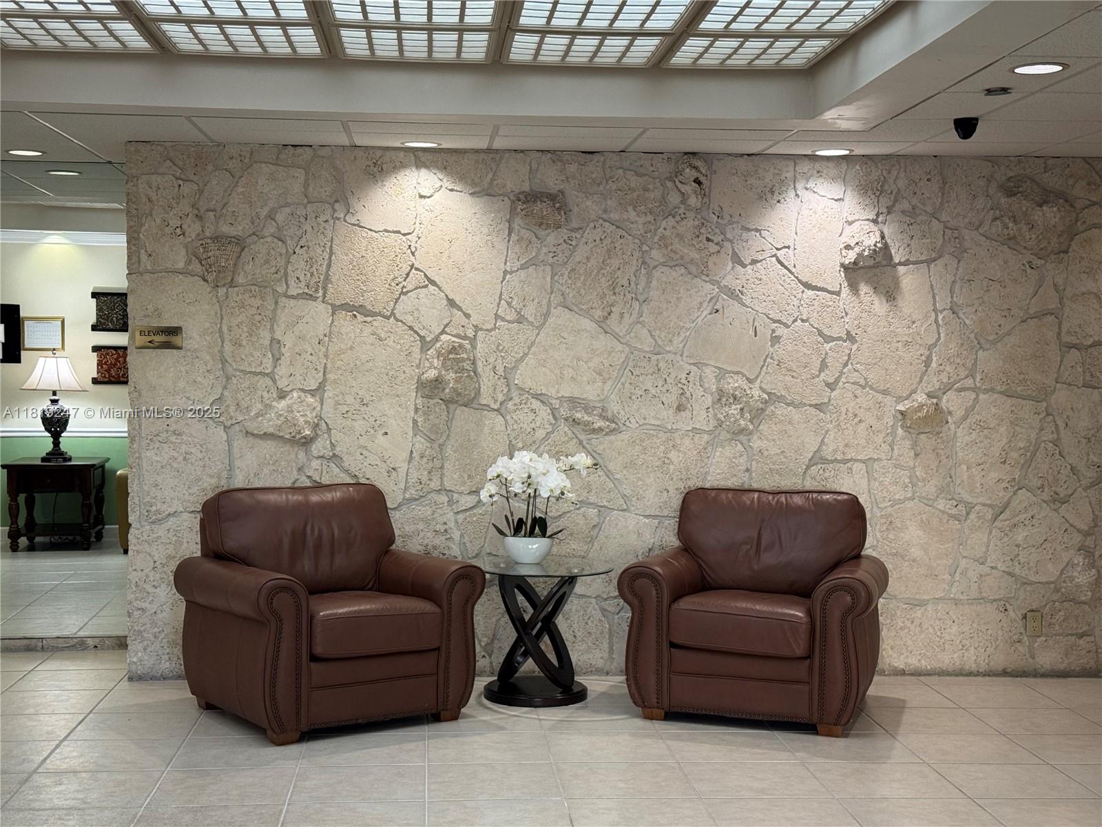 1100 St Charles Place, Unit 203 Pembroke Pines, FL 33026 - Photo 38 of 48 a living room with furniture and a fireplace