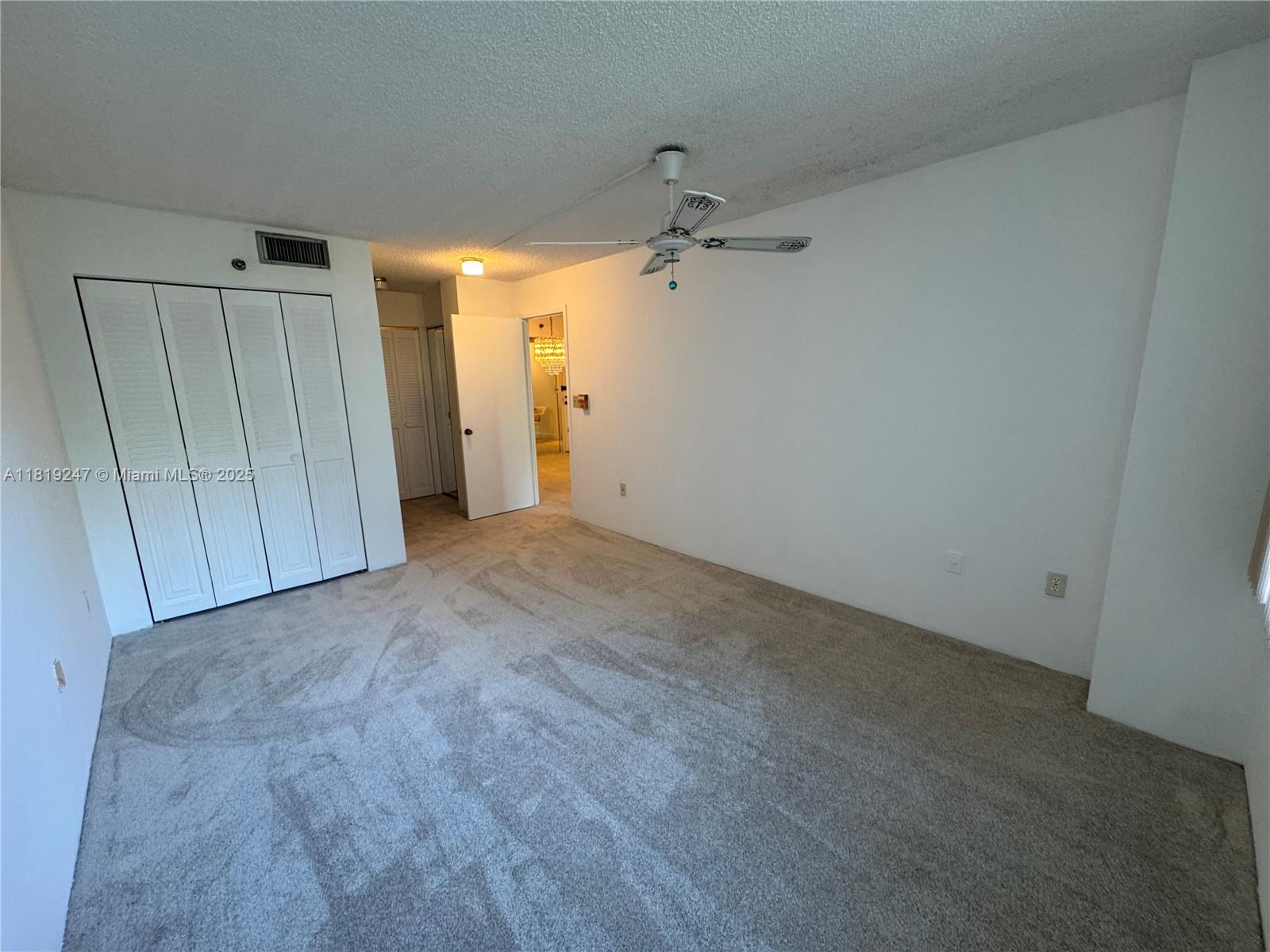 1100 St Charles Place, Unit 203 Pembroke Pines, FL 33026 - Photo 6 of 48 a view of hallway with a ceiling fan