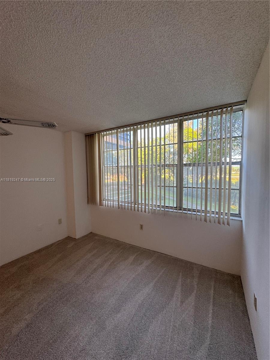1100 St Charles Place, Unit 203 Pembroke Pines, FL 33026 - Photo 10 of 48 a view of an empty room with a window