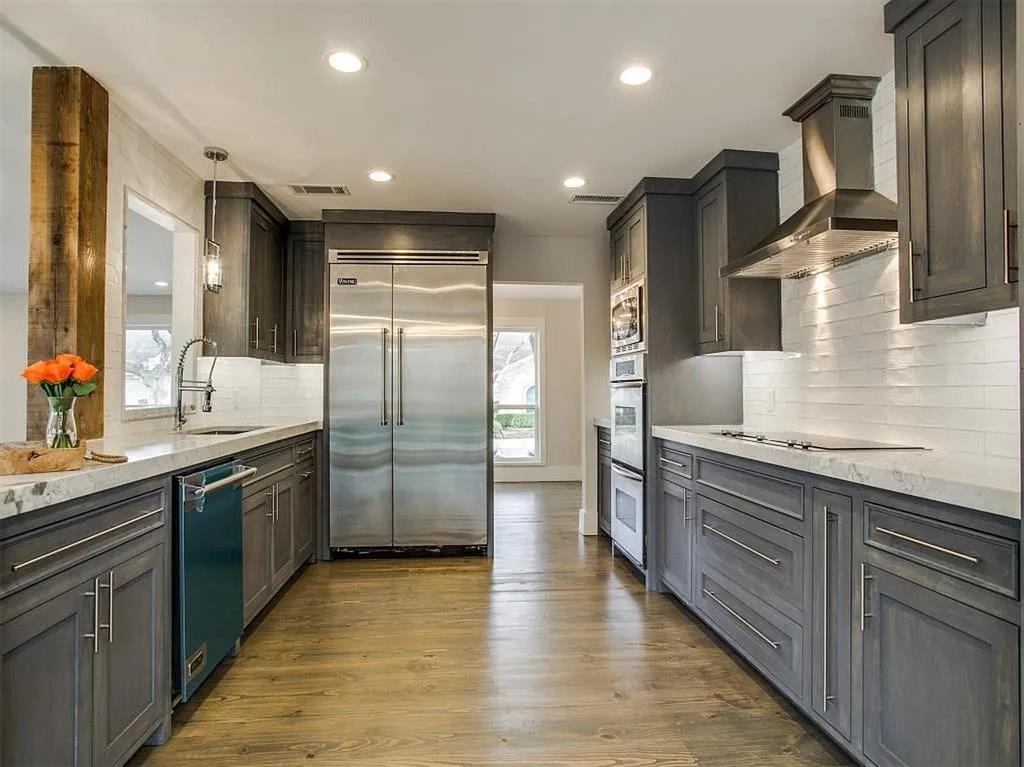 4310 Forest Bend Road Dallas, TX 75244 - Photo 13 of 34 a large kitchen with stainless steel appliances granite countertop a refrigerator and a sink