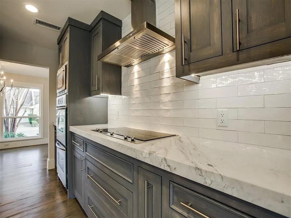 4310 Forest Bend Road Dallas, TX 75244 - Photo 15 of 34 a kitchen with granite countertop cabinets and stove top oven