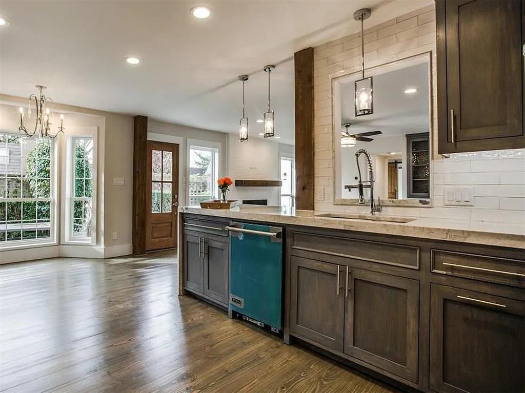 4310 Forest Bend Road Dallas, TX 75244 - Photo 16 of 34 a kitchen with stainless steel appliances granite countertop a sink a stove and a wooden floors