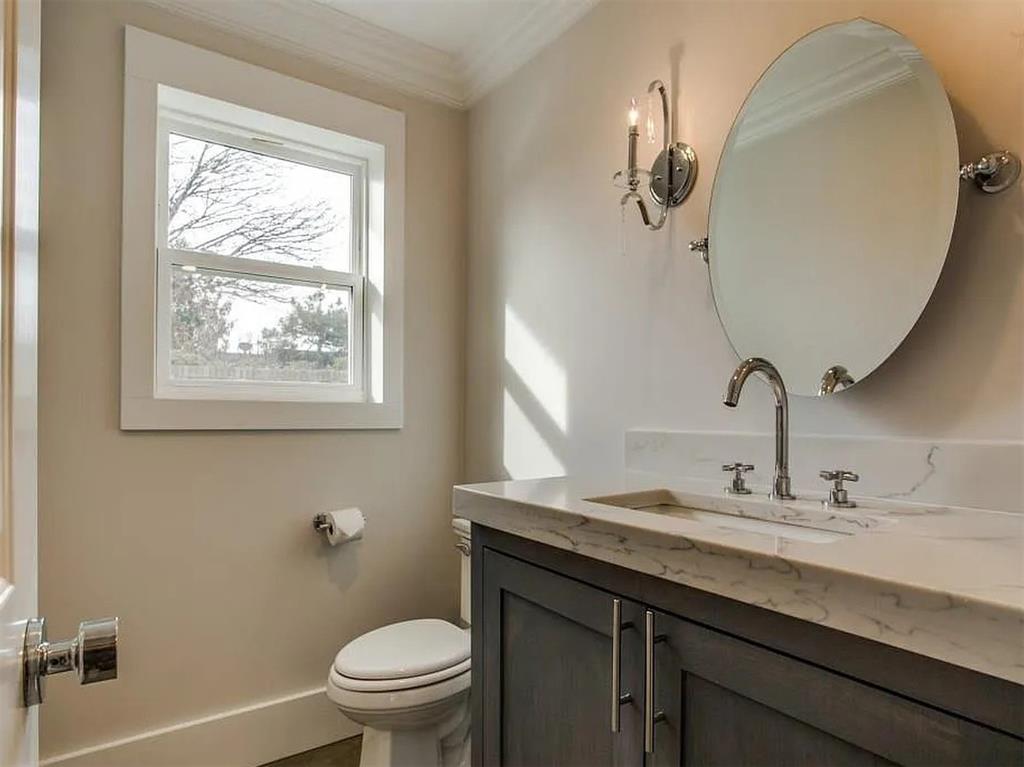 4310 Forest Bend Road Dallas, TX 75244 - Photo 27 of 34 a bathroom with a granite countertop sink a toilet and a mirror