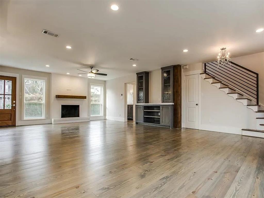 4310 Forest Bend Road Dallas, TX 75244 - Photo 7 of 34 an empty room with wooden floor and fireplace