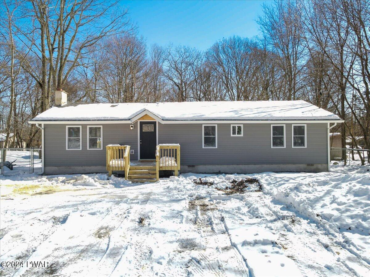166 Skyview Road Dingmans Ferry, PA 18328 - Photo 1 of 44 a front view of a house with yard porch and sitting area