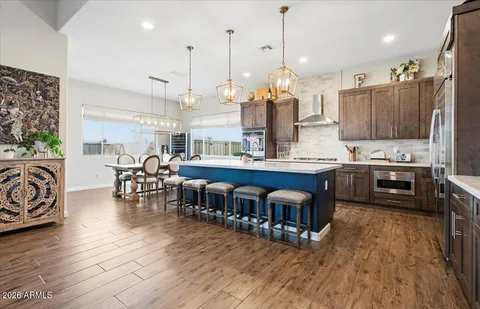a large kitchen with lots of counter space and dining table