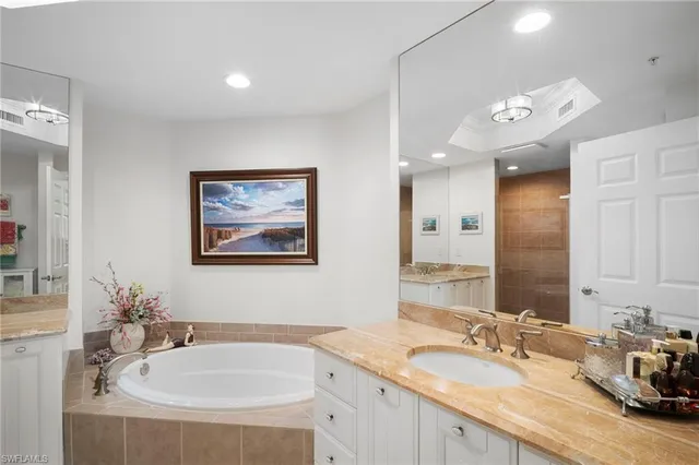a bathroom with a sink double vanity and a mirror