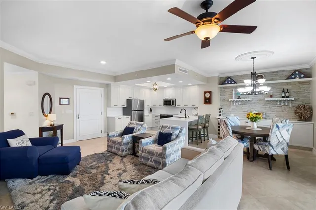 a living room with lots of furniture and view of kitchen