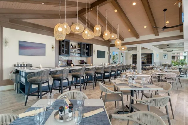 a group of people sitting at tables in a living room