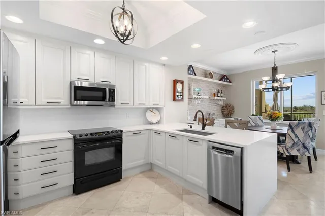 a kitchen with a sink stove and microwave