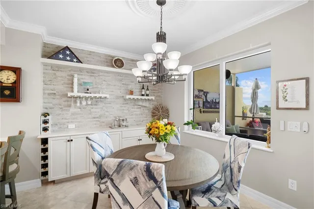 a dining room filled chandelier and wooden floor