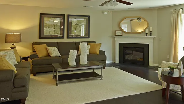 a living room with furniture and a fireplace
