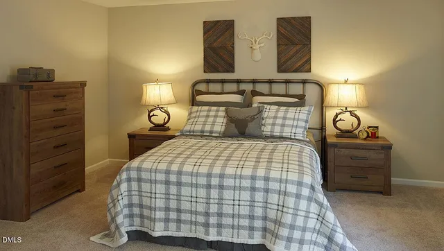 a bedroom with a bed and lamp