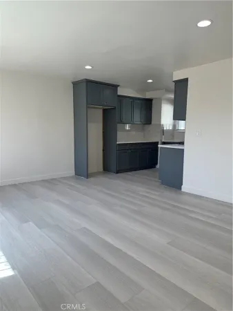 a view of kitchen with refrigerator and microwave