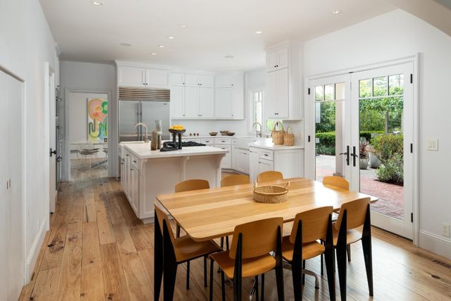a kitchen with sink a refrigerator and cabinets