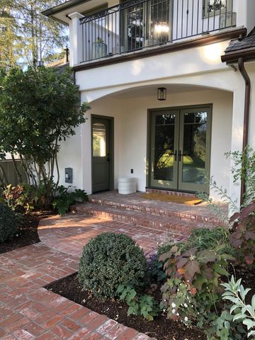 a view of a patio with table and chairs potted plants