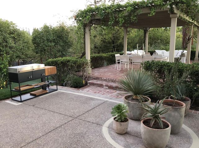 a backyard of a house with table and chairs