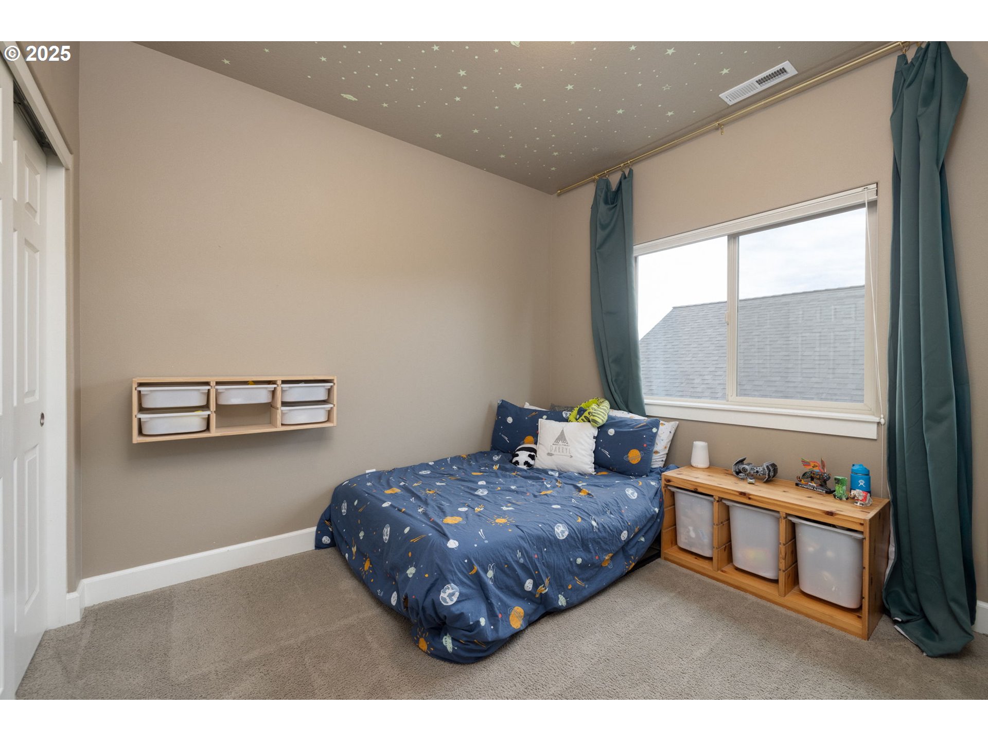 62905 Daniel Road Bend, OR 97701 - Photo 13 of 28 a bedroom with a bed and a window with outer view