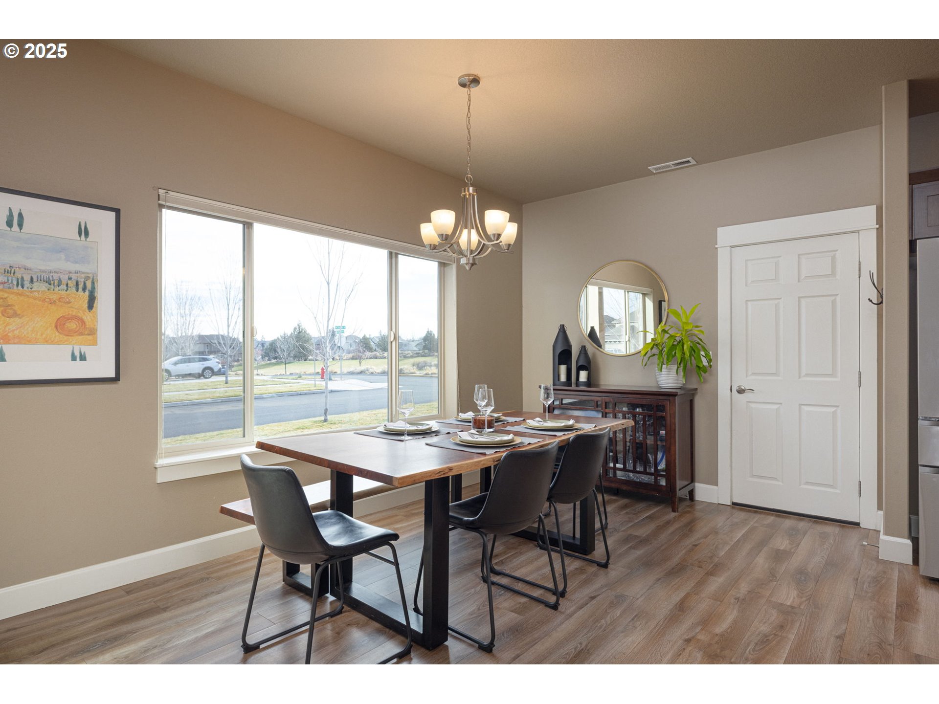 62905 Daniel Road Bend, OR 97701 - Photo 9 of 28 a view of a dining room with furniture and a chandelier