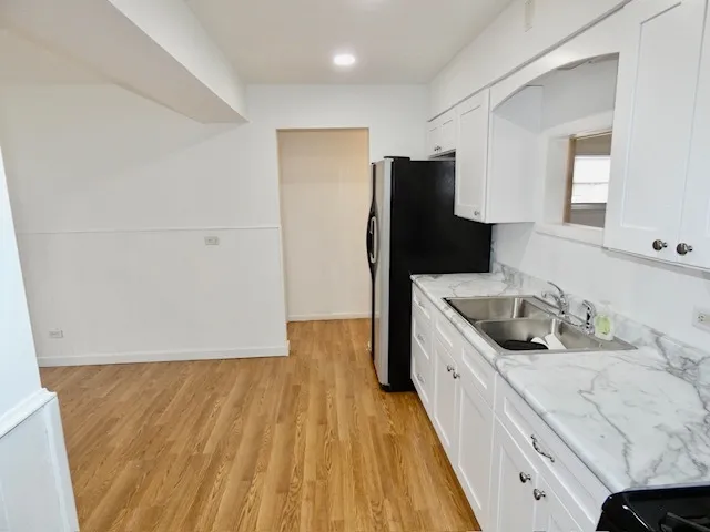 a kitchen with a sink a refrigerator and window