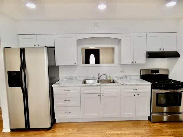 a kitchen with a refrigerator and a stove