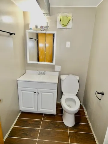 a bathroom with a toilet sink and mirror