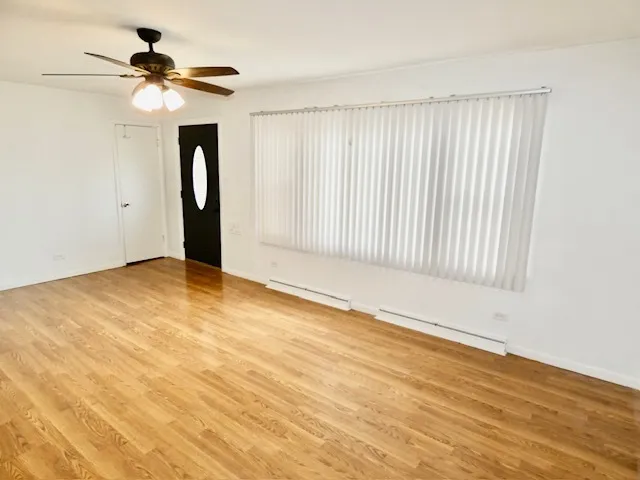 wooden floor in an empty room with a window